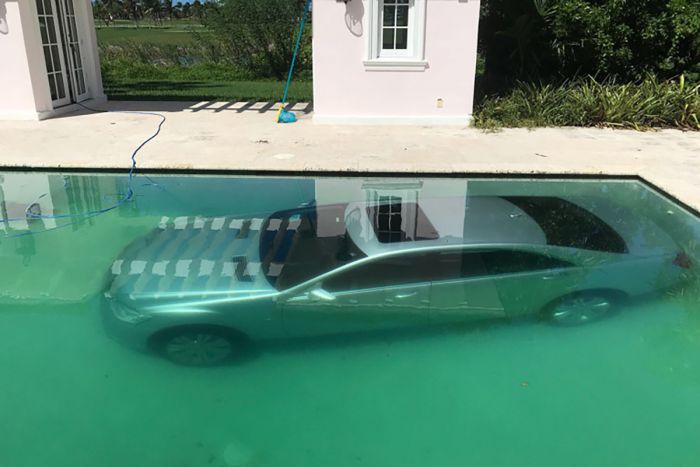 Hotshot banker says jilted lover drove his Benz into pool
